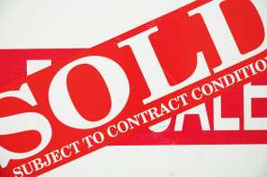 Conditional sold sign over for sale sign 