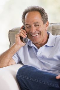Man relaxing on couch talking on phone